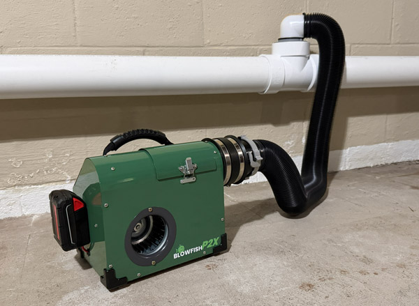 Blowfish P2X battery-powered plumbing smoke blower connected to a cleanout for leak testing